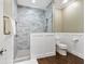Clean bathroom with walk-in shower, grey marble tile, and white wainscoting at 815 Tropical Cir, Sarasota, FL 34242