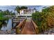 Wooden dock with walkway leading to waterfront property at 815 Tropical Cir, Sarasota, FL 34242
