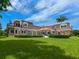 Brick house with large backyard, lush landscaping and partial water view at 815 Tropical Cir, Sarasota, FL 34242