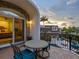 Private balcony with table and chairs, overlooking the pool and water at 815 Tropical Cir, Sarasota, FL 34242