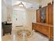 Elegant entryway with tile flooring, a charming bench, and an antique cabinet at 815 Tropical Cir, Sarasota, FL 34242