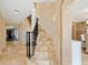 Elegant staircase with stone tile and wrought iron railing at 815 Tropical Cir, Sarasota, FL 34242