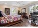 Bright bedroom with a comfortable bed, built-in shelves and home office at 815 Tropical Cir, Sarasota, FL 34242