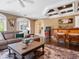 Game room with wet bar, arcade game, and comfortable seating at 815 Tropical Cir, Sarasota, FL 34242