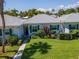 White condo building with green shutters and walkway at 139 Field E Ave # 139, Venice, FL 34285