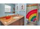 Bathroom with rainbow shower curtain and modern vanity at 1111 79Th Nw St, Bradenton, FL 34209