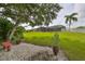 Expansive backyard with lush green grass, mature trees, and a screened-in porch, perfect for outdoor relaxation and entertaining at 17706 Bridlewood Ct, Parrish, FL 34219