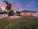 Evening view of backyard with fire pit and lanai at 17706 Bridlewood Ct, Parrish, FL 34219