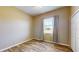 Bedroom with wood-look tile floors and a window with blinds at 17706 Bridlewood Ct, Parrish, FL 34219