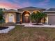 Attractive house exterior with a welcoming entryway and landscaping at 17706 Bridlewood Ct, Parrish, FL 34219