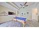 Entertaining game room featuring a pool table, tile floors, tray ceiling, and ample space for Gathering and friends at 17706 Bridlewood Ct, Parrish, FL 34219