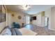 Cozy living room with tile floors, a plush sofa, and a TV, providing a welcoming space for relaxation and entertainment at 17706 Bridlewood Ct, Parrish, FL 34219