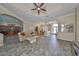 Spacious living room with tile flooring, modern furniture, tray ceiling and large windows offering ample natural light at 17706 Bridlewood Ct, Parrish, FL 34219