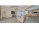 Spacious living room with tiled floors, a large TV, and French doors opening to a patio at 17706 Bridlewood Ct, Parrish, FL 34219