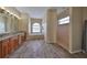 Main bathroom with double vanity, soaking tub, and walk-in shower at 17706 Bridlewood Ct, Parrish, FL 34219