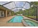Backyard pool and spa enclosed in a screened lanai overlooking the yard at 17706 Bridlewood Ct, Parrish, FL 34219