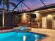 Outdoor oasis with a pool, spa, and summer kitchen at 17706 Bridlewood Ct, Parrish, FL 34219