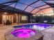 The pool and spa provide a place to relax during dusk in this backyard at 17706 Bridlewood Ct, Parrish, FL 34219
