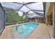 Screened pool with a basketball hoop at 17706 Bridlewood Ct, Parrish, FL 34219