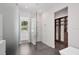 Modern bath with glass shower enclosure, textured wall, and closet access at 2234 Hibiscus St, Sarasota, FL 34239