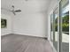 Bright bedroom featuring gray wood-look floors, a modern ceiling fan and glass sliding doors with views to the outdoor space at 2234 Hibiscus St, Sarasota, FL 34239