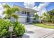 Contemporary two-story home with a well-manicured lawn, lush landscaping, and a spacious driveway at 2234 Hibiscus St, Sarasota, FL 34239