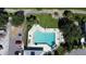 Aerial view of a geometrically-shaped community pool with lounge chairs and meticulously kept grounds at 3108 Royal Palm Dr, North Port, FL 34288