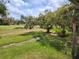 Backyard with manicured green lawn at 7673 Fairway Woods Dr # 706, Sarasota, FL 34238