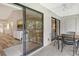 Screened balcony featuring sliding glass doors into living area and neutral tile flooring at 7673 Fairway Woods Dr # 706, Sarasota, FL 34238