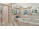 This bright bathroom features a large soaking tub, walk-in shower, and dual vanity at 7673 Fairway Woods Dr # 706, Sarasota, FL 34238