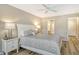 Cozy bedroom with a ceiling fan and connecting bathroom provides functionality at 7673 Fairway Woods Dr # 706, Sarasota, FL 34238