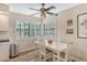 Bright dining area featuring a ceiling fan and a large window with shutter blinds at 7673 Fairway Woods Dr # 706, Sarasota, FL 34238