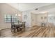 Bright dining area with luxury vinyl plank flooring and a decorative chandelier at 7673 Fairway Woods Dr # 706, Sarasota, FL 34238