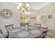 Open-concept dining room featuring a decorative chandelier and access to the living areas at 7673 Fairway Woods Dr # 706, Sarasota, FL 34238