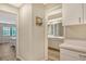 Hallway connecting the bedroom and bathroom with natural light and storage at 7673 Fairway Woods Dr # 706, Sarasota, FL 34238