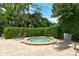 Relaxing community hot tub surrounded by lush greenery, providing a tranquil escape for residents at 7673 Fairway Woods Dr # 706, Sarasota, FL 34238
