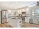 Well-lit kitchen features stainless steel appliances, white cabinets, and a center island at 7673 Fairway Woods Dr # 706, Sarasota, FL 34238