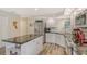 The updated kitchen features stainless appliances, white cabinets, and a large island at 7673 Fairway Woods Dr # 706, Sarasota, FL 34238