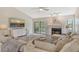 Comfortable living room features a fireplace, balcony access, and an open-concept design at 7673 Fairway Woods Dr # 706, Sarasota, FL 34238