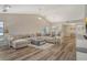 Bright living room with wood floors, vaulted ceiling, and large sectional sofa at 7673 Fairway Woods Dr # 706, Sarasota, FL 34238