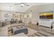 Bright living room boasts wood floors, vaulted ceiling, and media center at 7673 Fairway Woods Dr # 706, Sarasota, FL 34238