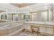 The main bathroom features a garden tub with tile surround, glass enclosed shower and dual sink vanities at 7673 Fairway Woods Dr # 706, Sarasota, FL 34238