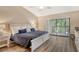 Cozy main bedroom with a king bed and a private balcony at 7673 Fairway Woods Dr # 706, Sarasota, FL 34238