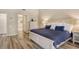 Bright main bedroom features a large bed, wood floors, and ample closet space at 7673 Fairway Woods Dr # 706, Sarasota, FL 34238