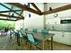 Outdoor kitchen with a long table, seating, brick floor and sink at 7673 Fairway Woods Dr # 706, Sarasota, FL 34238