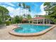 Community pool with a covered seating area at 7673 Fairway Woods Dr # 706, Sarasota, FL 34238