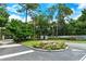 Community entrance with landscaping and Fairway Woods signage at 7673 Fairway Woods Dr # 706, Sarasota, FL 34238