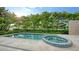 Inviting heated pool and spa with lush landscaping at 2945 Pyrula Dr, Longboat Key, FL 34228