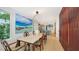 Open concept dining room with hardwood floors and view into kitchen at 2945 Pyrula Dr, Longboat Key, FL 34228