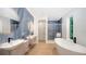 Luxurious bathroom with soaking tub, double vanity, and marble accents at 2945 Pyrula Dr, Longboat Key, FL 34228